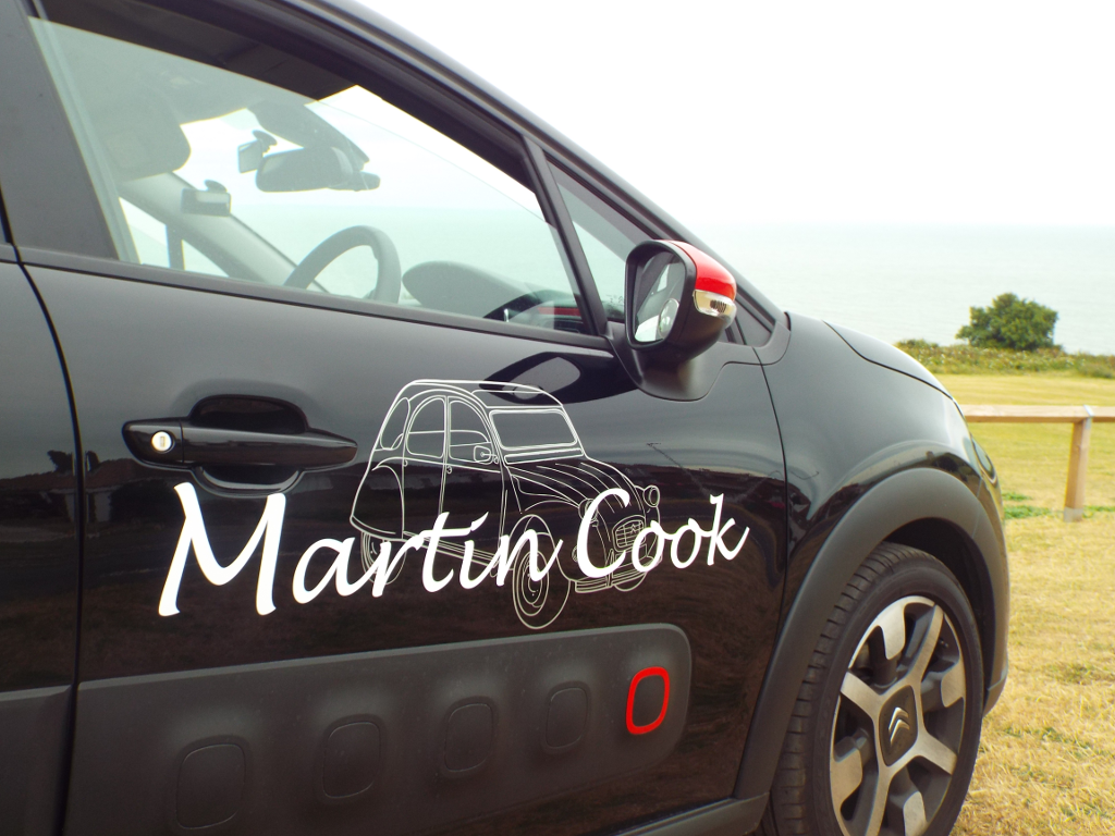 Front of the instructor's car from the side, showing the logo